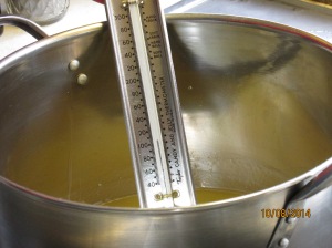 Getting the right temperature before combining the Lye into the oil!